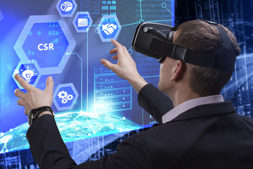 Business, Technology, Internet and network concept. Young businessman working on a virtual screen of the future and sees the inscription: CSR