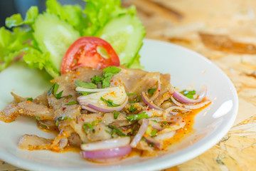 Hot and Spicy Thai food, pork nam tok or chili sour mix.