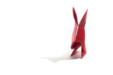 Colored origami rabbits over a white background