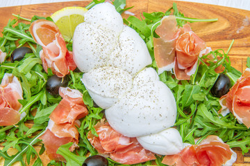 chopping board with rocket ham and mozzarella