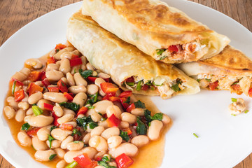 burrito with garnish of beans