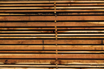 Stack of different size cut wood planks for construction