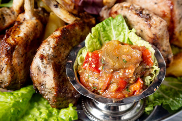 Delicious grilled vegetables with lamb ribs close up