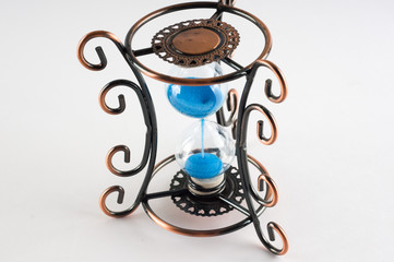 Vintage hourglass with curls patterns on the edges. Presuposes (perespevshie) blue sand in them.