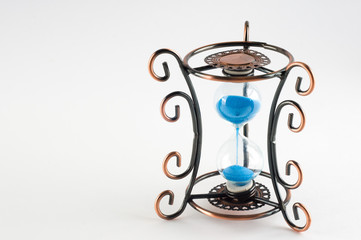 Vintage hourglass with curls patterns on the edges. Presuposes (perespevshie) blue sand in them.
