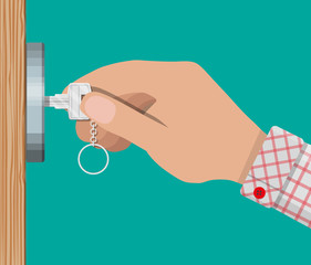 Key in hand opens wooden door.