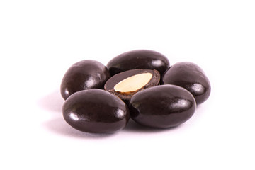 group of nuts in chocolate on a white background. Part cut in half.