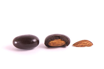 group of nuts in chocolate on a white background. Part cut in half.