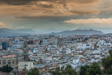 Fototapeta na wymiar Rolling clouds over Malaga cityscape