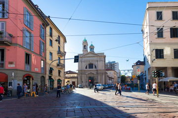 Tourists and local people are crossing street  near Santa Maria della Vittoria . MILAN, ITALY