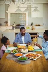 Family having meal on dinning table at home