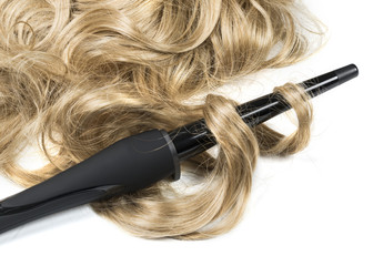 Naklejka premium woman long haired making hairstyle iron.