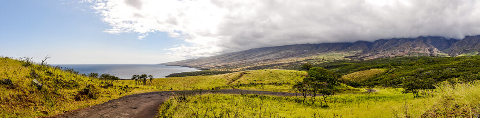 XXL panorama view of Piilani Highway on the island of Maui, Hawaii, USA. Also known as the back road to Hana, the highway (Hwy 31) leads along Mt. Haleakala's southern flank. Sunny day with clouds.