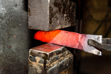 Forging molten metal. Making knives.
