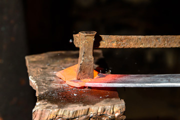 Cutting hot metal in the smithy.