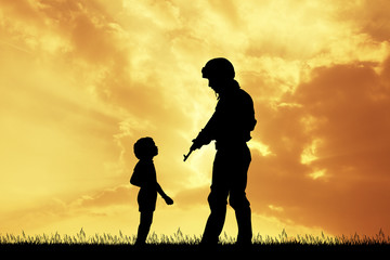 soldier and child at sunset