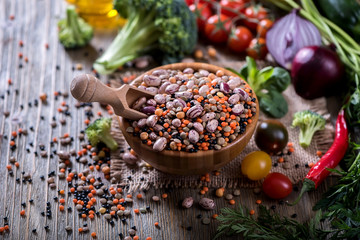 Cooking ingredients with vegetables, lentils, rice and beans in bowl, vegetarian and vegan food concept, copy space healthy food background