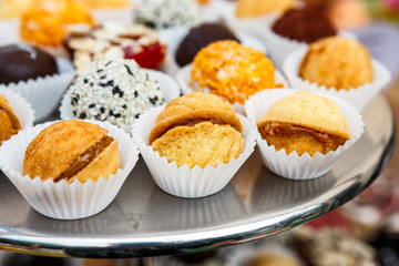 Different candies, cookies and biscuits on banquet table.