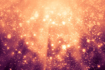 Golden abstract sparkles or glitter lights. Festive gold background. Defocused circles bokeh or particles. Template for design