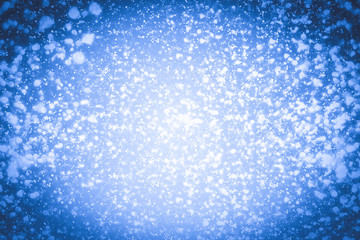 Abstract bokeh or glitter lights on blue  background. Circles and defocused particles. Design template