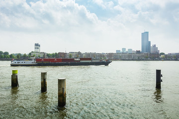 Container ship passes the Nieuwe Maas river in Rotterdam