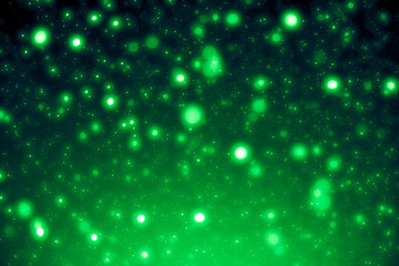 Fototapeta premium Green abstract background. Bokeh or round defocused particles or glitter lights