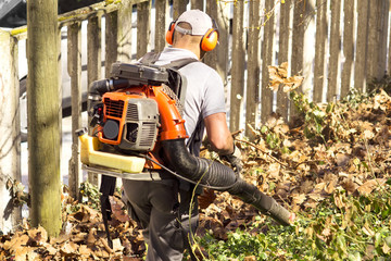 blower backpack with  gardener working in city park , blowing  leafs