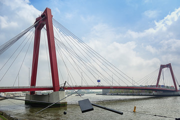 The bridge Willemsbrug in Rotterdam with modern art in the foreground
