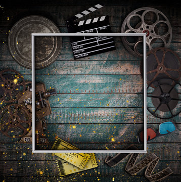 Cinema concept of vintage film reels, clapperboard and other tools.