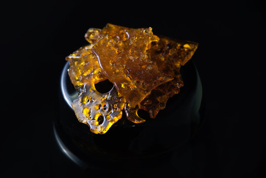Marijuana oil concentrate aka shatter isolated on black background