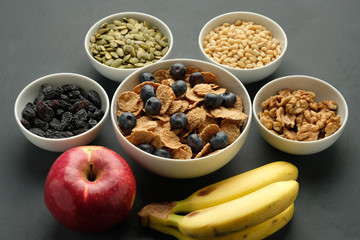 Healthy food. Multi grain flakes with blueberry, nuts and fruits for breakfast.