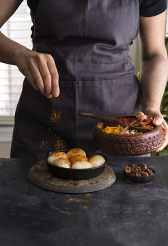 Woman sprinkling tumeric on boiled eggs 