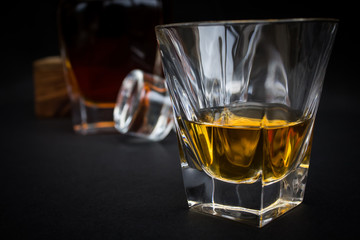 Whiskey Glass With Decanter On Black Background