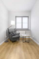 Grey armchair with small table