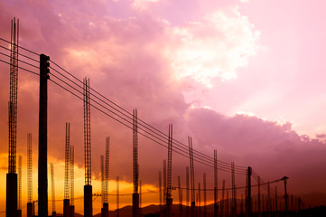 Fototapeta na wymiar Construction site view of scaffolding poles on building site sunset