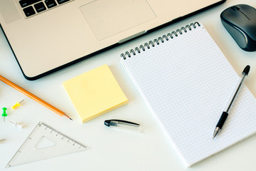 white workspace with laptop, notebook, sketchbook on white background. Flat lay, top view office table desk. Freelancer working place