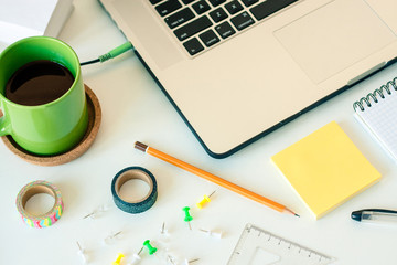 Workspace with laptop notebook stick notes on white background. Template mock up with copy space for text. Working at home or online concept