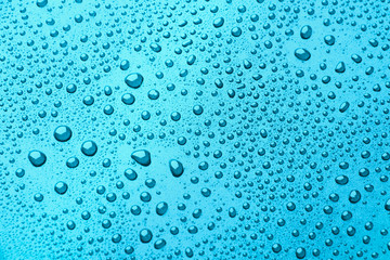 Drops of water on a color background. light blue