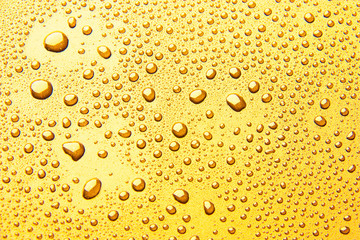 Drops of water on a color background. Yellow