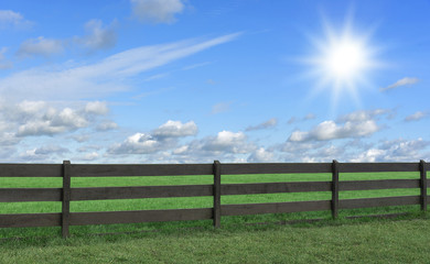 Farm. Field with grass and a fence.