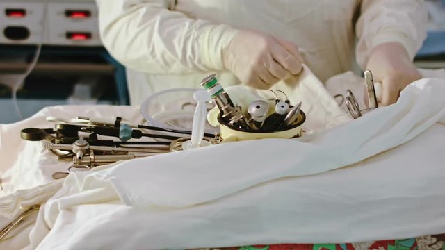 Operating. A nurse prepares the tools for Sergery. 