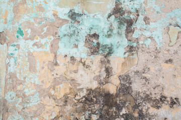 Weathered, faded and peeled off colorful concrete wall texture background.
