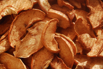 Dried brown apple chips macro background.