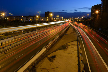 Rays of lights, car lights on a road, at night
