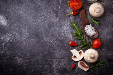 Fototapeta na wymiar Mushrooms, tomatoes, rosemary, salt and oil. Food background