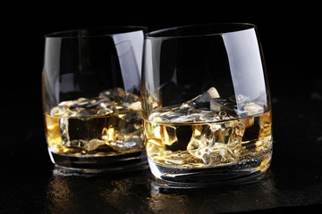 whiskey with ice on a wooden table
