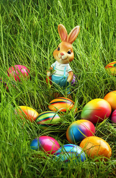 Sugar rabbit and easter eggs on meadow.