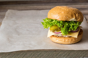 home made tasty burgers on wooden table.
