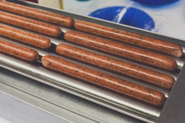 Sausages on professional machine for hot dog preparation