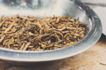 Small anchovy fish grilled at barbecue